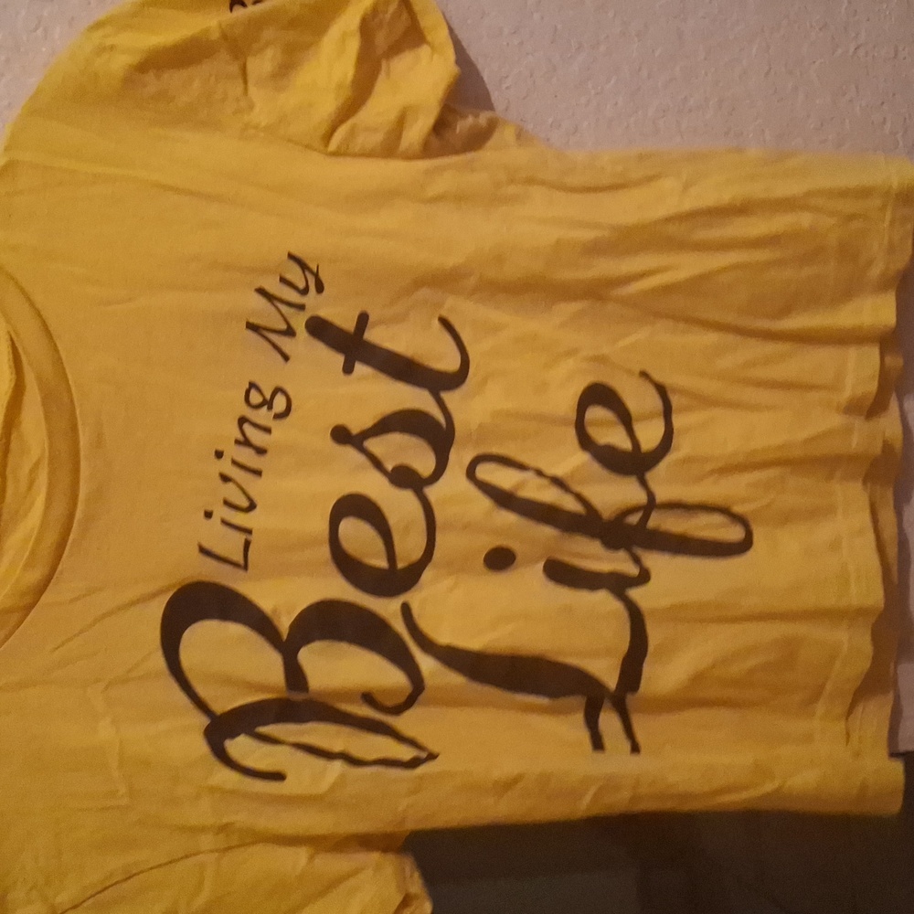 A yellow crop top that says living my best life